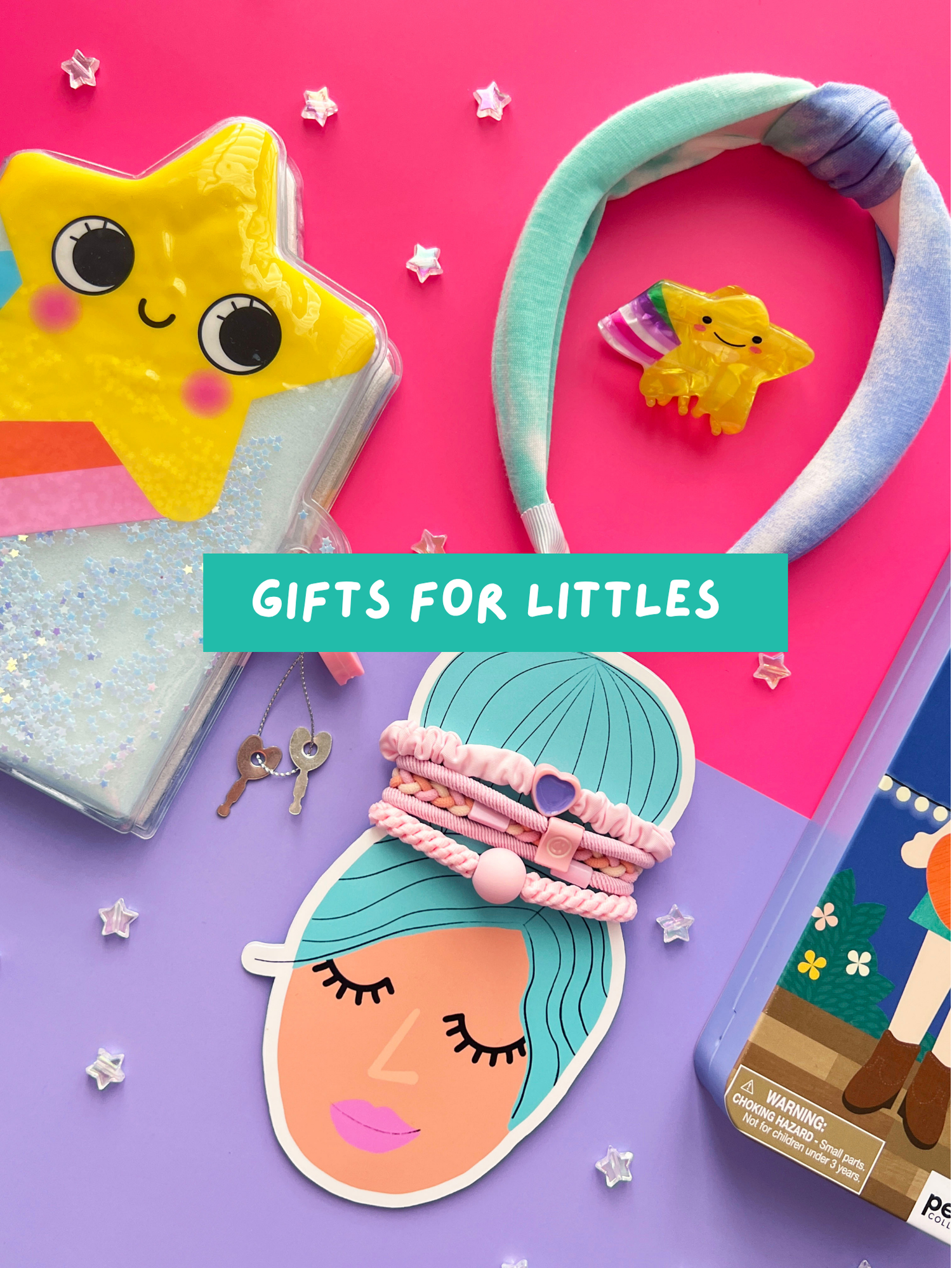 Gifts for little girls featuring a yellow star glitter notebook, blue headband, hair ties, and star hair clip.