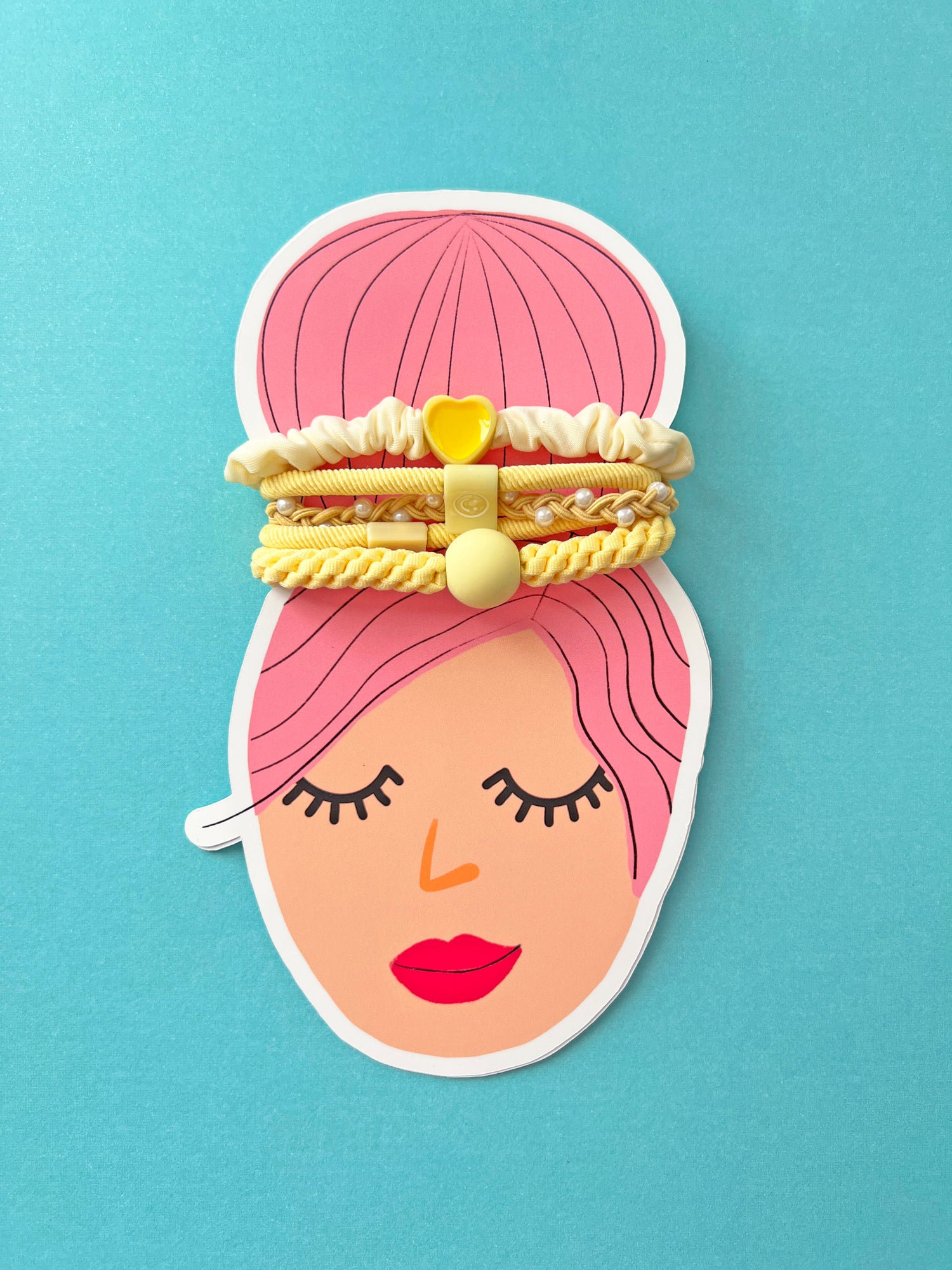 Cute hair accessories for girls featuring yellow hair ties and a scrunchie on a colorful graphic card.
