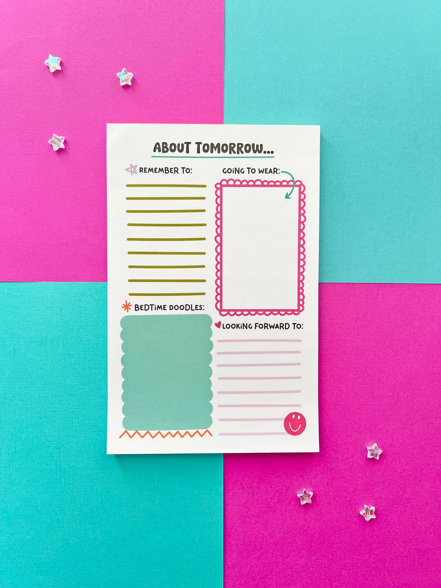 Kids bedtime and morning routine notepad on colorful background. ‘About Tomorrow’ daily planning pad for children with sections for reminders, outfit planning, doodles, and happy thoughts.