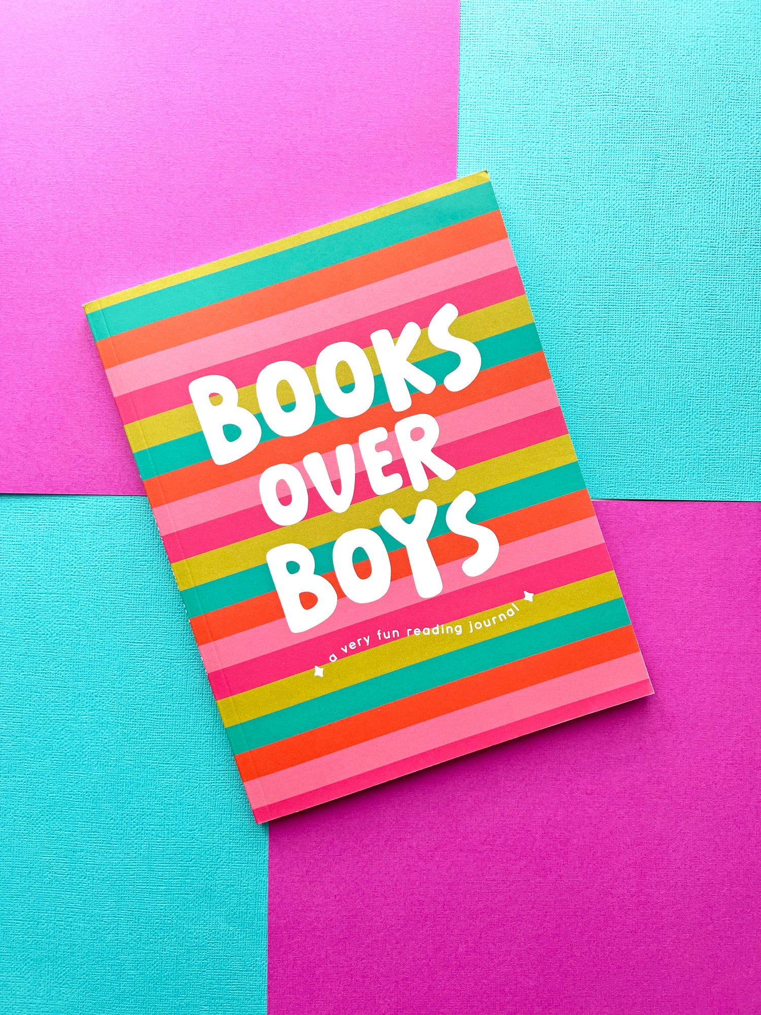 Books Over Boys a very fun reading journal for girls with a colorful striped cover on a bright color block background.