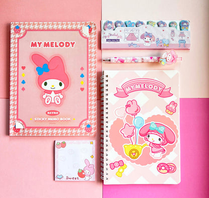 Flat lay arrangement of cute pink cartoon bunny journals, correction tape, and pastel school accessories from a mystery package.