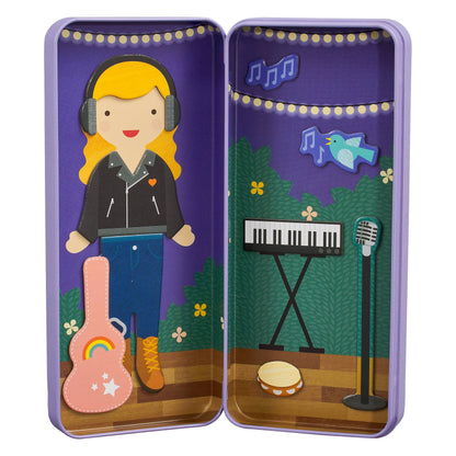 Inside view of the magnetic tin showing the character dressed up with a keyboard, microphone, and stage backdrop.