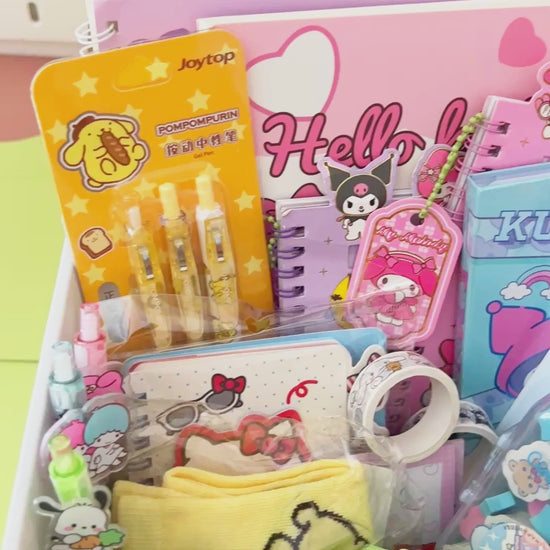 Video showing a close-up unboxing and packing process of a colorful pastel cartoon stationery mystery box gift.